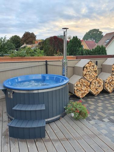 a hot tub on the deck of a house at KK Apartment in Ventspils