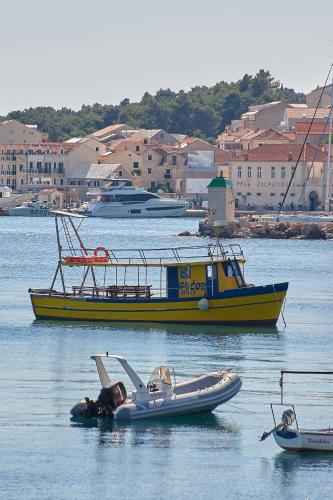 a man is laying in an inflatable boat in the water at Guest House Marija in Bol