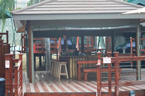 a pavilion with tables and chairs on a wooden deck at Luxury Tented Village @ Urban Glamping in St Lucia