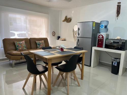 a kitchen with a table and chairs and a refrigerator at Condominios Brisas Zona Hotelera in Cancún