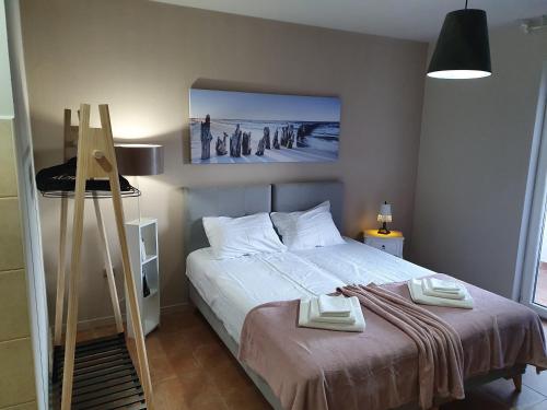 a bedroom with a bed with two towels on it at Little Sea Stars, Tivat in Tivat