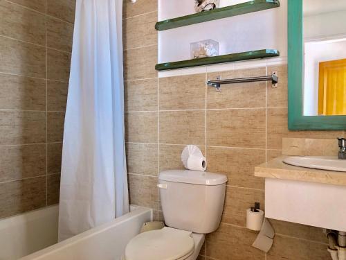 a bathroom with a toilet and a tub and a sink at Beach Day @CadaquesCaribe Bayahibe in Bayahibe
