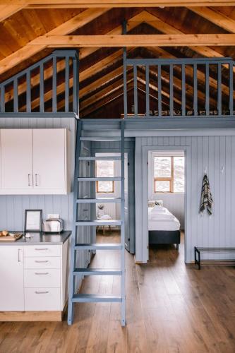 a room with a bunk bed and a kitchen at Hlid Cottages in Myvatn