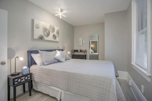 a bedroom with a large white bed and a window at Stunning Couples Retreat - Downtown Getaway in Grand Rapids