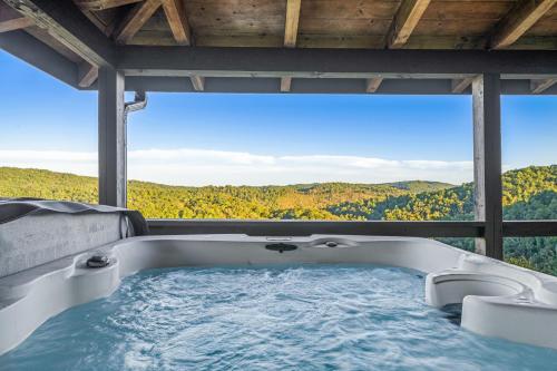 a bath tub with a view of the mountains at The Overlook at Talking Rock Creek Resort in Ranger