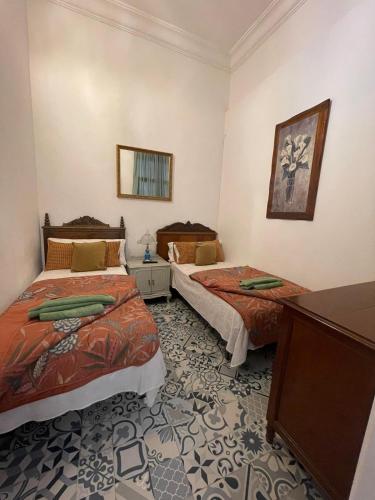 a hotel room with two beds and a mirror at Dream Escape in Santa Cruz de Tenerife