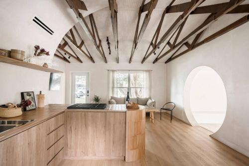 a kitchen with wooden cabinets and a ceiling with beams at Casa Terra Lumi - at lumicollection in Fort Lauderdale