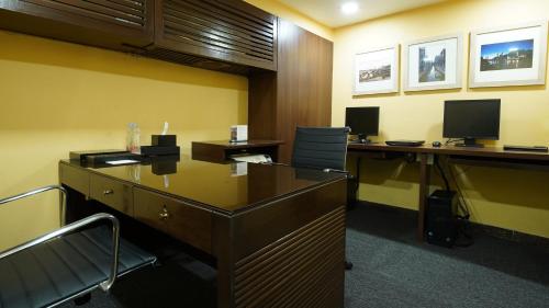an office cubicle with two desks and two computer monitors at InterContinental Marine Drive Mumbai by IHG in Mumbai