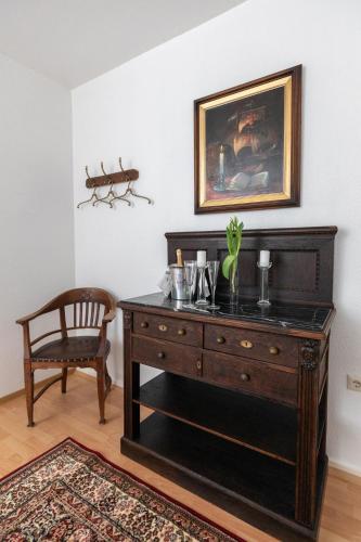 a dresser in a room with a picture on the wall at Schmökermühle in Andernach