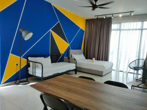 a living room with a blue and yellow wall at New 2BR Georgetown Warm and Lovely Homestay 10pax-无敌美景两房民宿 Beacon Executive Suite in George Town