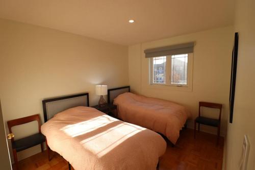 a bedroom with two beds and a window at Best, Prime location! Next to Vaughan mills! in Vaughan