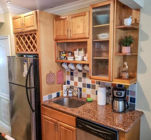 a kitchen with a sink and a refrigerator at RETRO RETREAT in DTSP - Explore the downtown area in St. Petersburg