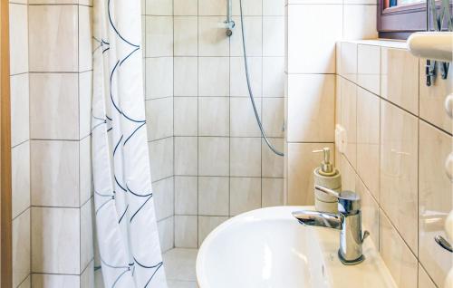 a bathroom with a sink and a shower at Stunning Home In Stawiguda With Kitchenette in Stawiguda