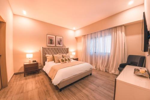 a bedroom with a large bed and a window at Fully Serviced Apartment at Regatta Living - 2C in Santo Domingo