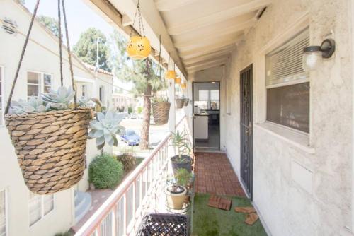 a balcony with potted plants on a house at Cool and Cozy Pad Close to Everything in Los Angeles