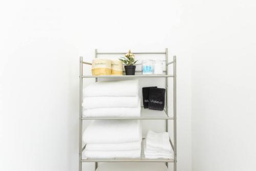 a metal towel rack with towels on a white wall at Inviting Home in Historic Leimert Park in Los Angeles