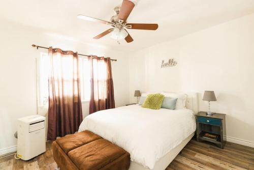 a bedroom with a bed and a ceiling fan at Spring Charmer In The Heart Of The City in Los Angeles