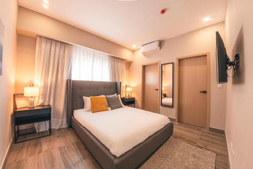 a bedroom with a bed and a window at Fully Serviced Apartment at Regatta Living - 2G in Santo Domingo