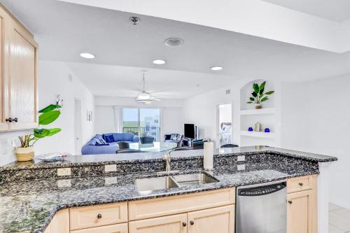 a kitchen with a sink and a counter top at Oceanwalk Suite in New Smyrna Beach