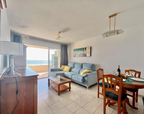 a living room with a couch and a table at Apartamentos Apolo 16 in Calpe