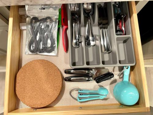 a drawer filled with kitchen utensils and a spatula at Immaculate Newly Renovated 1 Bedroom Apt Near NYC in Bergenfield