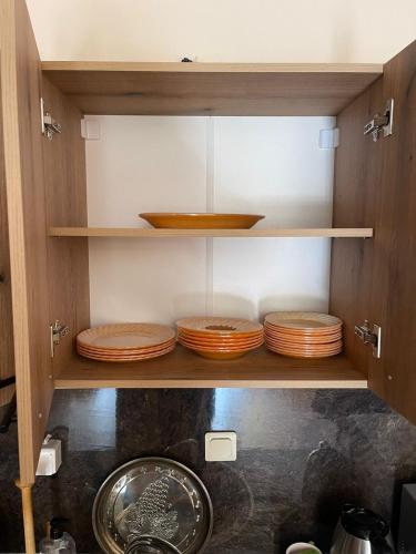 a cabinet filled with wooden plates and bowls at Borovets Sequoia2 Apartment no 5 in Borovets