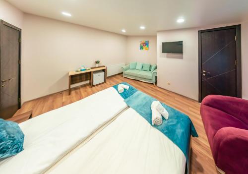 a living room with a bed and a couch at Hotel Classic Suites in Tbilisi City