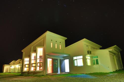 a large house with lights on at night at Meet Canaan in Xikou