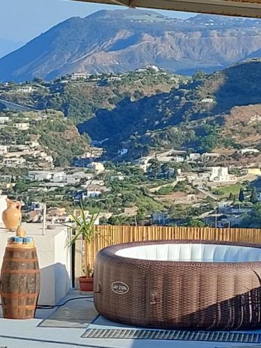 a bath tub on a balcony with a mountain view at Casa tra Cielo e Mare in Lipari