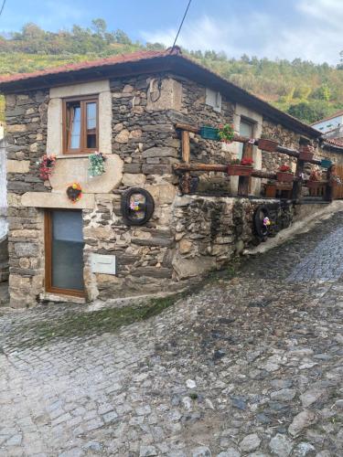 a stone house on the side of a street at Casa das Flores in Lamego