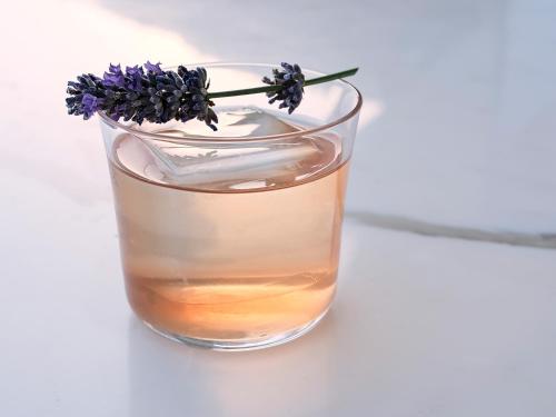 a glass of whiskey with a flower in it at The Maybourne Riviera, Maybourne in Roquebrune-Cap-Martin