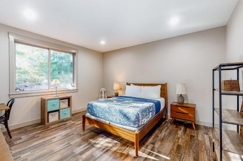 a bedroom with a bed and a window at Siuslaw Tides 1 in Florence