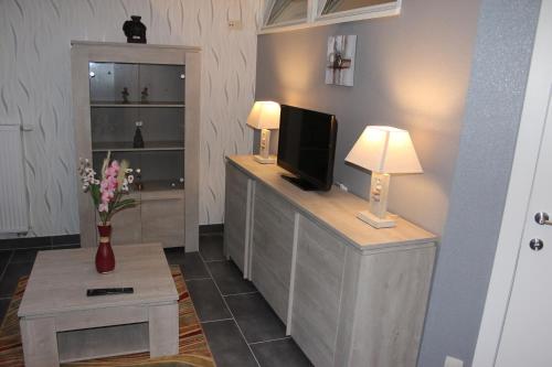 a living room with a flat screen tv on a counter at Orchidee in Comines