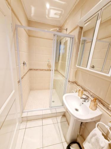 a bathroom with a shower and a sink at Luxurious Pvt Apartment , Pool, Jaccuzi & Aircons in Sandton