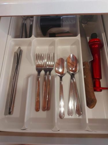 a tray with silver utensils on a shelf at Chalés Alpes do Vale- Gramado in Gramado