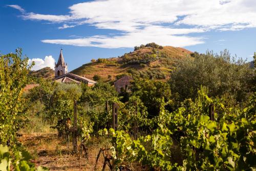 a church on top of a hill with a church on it at Palazzo Previtera Hotel & Restaurant in Linguaglossa