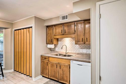 a kitchen with wooden cabinets and a sink at Cozy Ruston Townhome Less Than 1 Mi to Louisiana Tech in Ruston