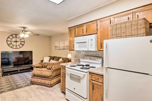 a kitchen with a white refrigerator and a living room at Cozy Ruston Townhome Less Than 1 Mi to Louisiana Tech in Ruston