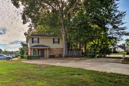 a house with a tree in front of a driveway at Cozy Ruston Townhome Less Than 1 Mi to Louisiana Tech in Ruston