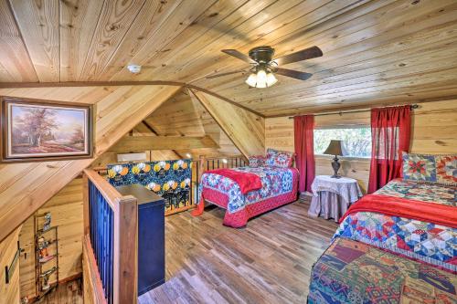 a bedroom with two beds and a ceiling fan at Cozy Tree Top Cabin about 3 Mi to Lake Hamilton in Hot Springs