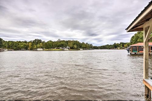 a boat is docked on a body of water at Eatonton Getaway on Lake Sinclair with Dock! in Resseaus Crossroads