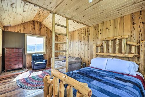 een slaapkamer met een bed in een kamer met houten wanden bij Luxe Heber City Cabin and Hot Tub and Guest House in Heber City