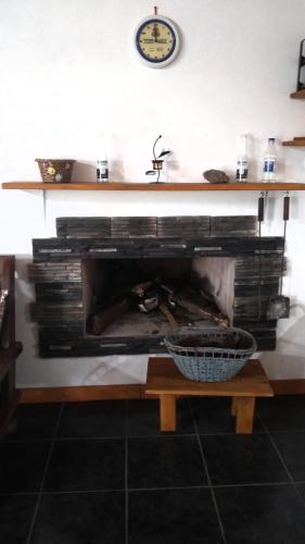 a fireplace with a large stack of books at Los Agapantos in Concordia
