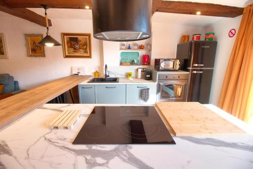 a kitchen with a black refrigerator and a counter top at Cuencaloft La Casa Del Pintor in Cuenca