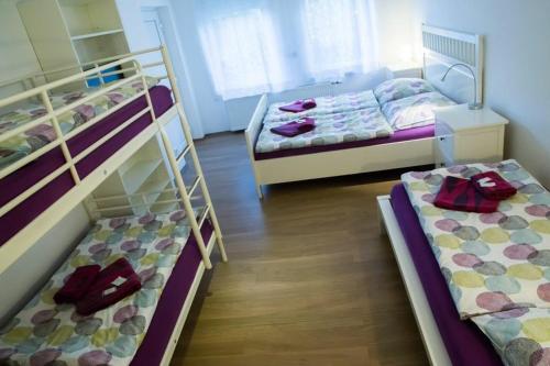 a room with three bunk beds in it at Bed & Breakfast BonnaNotte in Essen