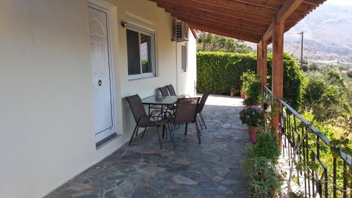 a patio with a table and chairs on a house at Villa Erofili Plakias south Rethimno Crete in Asómatoi