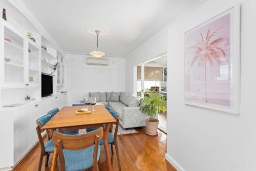 a living room with a table and a couch at The Little Lake House in Primbee