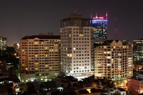 a city skyline at night with tall buildings at The Lancaster Saigon Service Apartment in Ho Chi Minh City