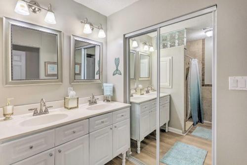 a bathroom with two sinks and a shower at Family Home with Private Pool and Fenced Yard! in Fort Walton Beach