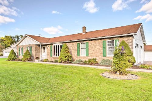 a brick house with a grass yard at Charming Lewisburg Home with Hot Tub and Games! in Lewisburg